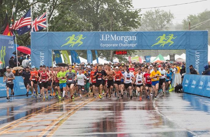 rain-soaked participants of the 2017 JPM Corporate Challenge at the starting line